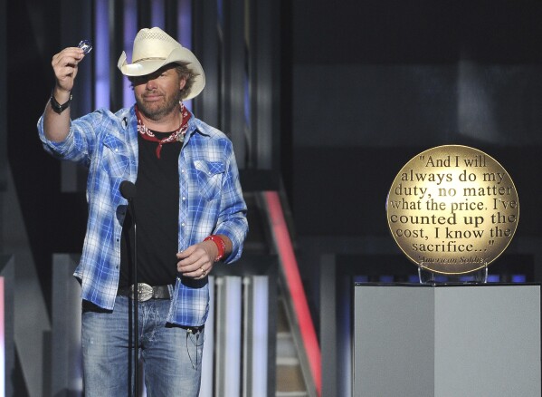FILE - Toby Keith performs at ACM Presents an All-Star Salute to the Troops on Monday, April 7, 2014, in Las Vegas. Keith participated in 18 USO tours, performing for more than 250,000 service members in his lifetime. Keith, who died of cancer on Monday, Feb. 5, 2024, at age 62, is being celebrated for his immense catalog of songs. But his 2002 track “Courtesy Of The Red, White And Blue (The Angry American)