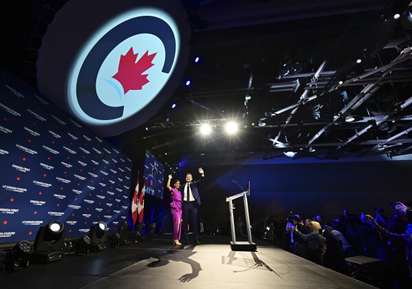 Conservative Leader Pierre Poilievre and his wife Anaida Poilievre arrive on stage at his campaign headquarters on election night, in Ottawa, Tuesday, April 29, 2025.(Spencer Colby/The Canadian Press via AP)