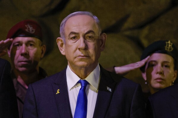 FILE - Israeli Prime Minister Benjamin Netanyahu, front, attends a wreath-laying ceremony marking Holocaust Remembrance Day in the Hall of Remembrance at Yad Vashem, the World Holocaust Remembrance Centre, in Jerusalem, Israel, on May 6, 2024. The cease-fire proposal announced by President Joe Biden has placed Prime Minister Netanyahu at a crossroads, with either path likely to shape the legacy of Israel's longest-serving and deeply divisive leader. (Amir Cohen/Pool Photo via AP, File)