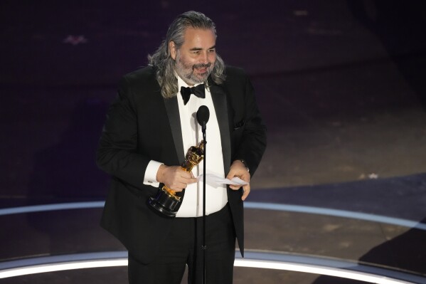 Hoyte van Hoytema accepts the award for best cinematography for "Oppenheimer" during the Oscars on Sunday, March 10, 2024, at the Dolby Theatre in Los Angeles. (AP Photo/Chris Pizzello)