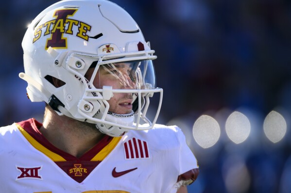Iowa State quarterback Hunter Dekkers during a break in action against Kansas in the second half of an NCAA college football game Saturday, Oct. 1, 2022, in Lawrence, Kan. Dekkers has been accused of gambling on Cyclone sports events, including a football game, and was charged Tuesday, Aug. 1, 2023, with tampering with records related to an Iowa Criminal Division investigation into sports gambling. (AP Photo/Reed Hoffmann, File)