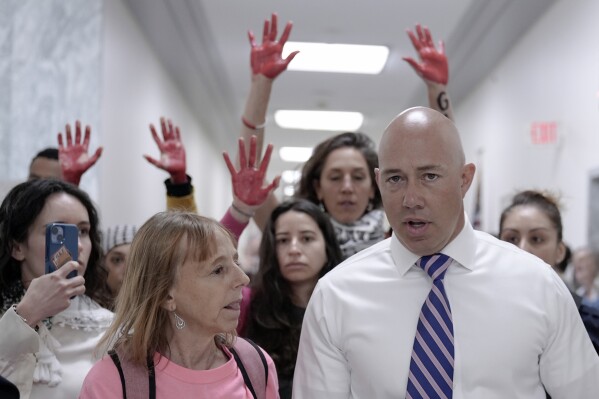 Rep. Brian Mast, R-Fla., speaks with protesters outside of the conference room during the House Committee on Education and the Workforce hearing on "Columbia in Crisis: Columbia University's Response to Antisemitism" on Capitol Hill in Washington, Wednesday, April 17, 2024. (AP Photo/Mariam Zuhaib)