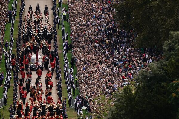 The Ceremonial Procession of the coffin of Queen Elizabeth II travels down the Long Walk as it arrives at Windsor Castle for the Committal Service at St George's Chapel, in Windsor, England, Monday, Sept. 19, 2022. (Aaron Chown/Pool photo via AP)