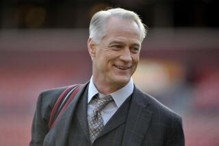 FILE - Former Dallas Cowboys standout and longtime NFL on FOX game analyst Daryl Johnston stands on the field prior to an NFL football game between the Philadelphia Eagles and Washington Redskins, on Dec. 30, 2018, in Landover, Md. Johnson is executive vice president of football operations of the USFL. As the league prepares for Sunday night’s championship game between the Birmingham Stallions and Philadelphia Stars at the Pro Football Hall of Fame in Canton, Ohio,  where it goes from here is the bigger question.(AP Photo/Mark Tenally, File)