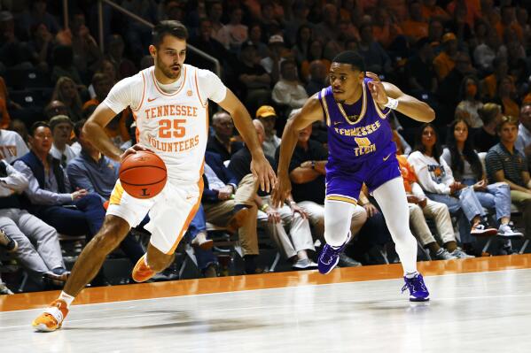 Tennessee guard Santiago Vescovi (25) drives past Tennessee Tech guard Ty Perry (0) during the first half of an NCAA college basketball game Monday, Nov. 7, 2022, in Knoxville, Tenn. (AP Photo/Wade Payne)