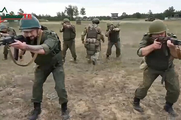 FILE - In this photo taken from video released by Belarusian Defense Ministry via VoenTV on Friday, July 14, 2023, Belarusian soldiers attend a training by mercenary fighters from Wagner private military company near Tsel village, about 90 kilometers (about 55 miles) southeast of Minsk, Belarus. Thousands of Russia-linked Wagner group mercenaries have arrived in Belarus since the group's short-lived rebellion, a military monitoring group said Monday. (Belarusian Defense Ministry via VoenTV via AP, File)