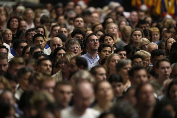 People watch Pope Francis as he leads a prayer for peace inside St. Peter's Basilica, at The Vatican, Friday, Oct. 27, 2023. (AP Photo/Andrew Medichini)