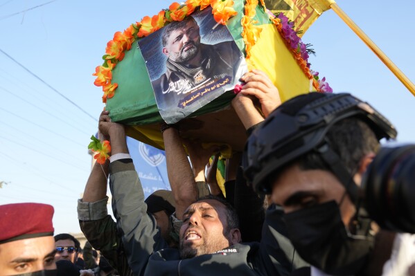Fighters from the Popular Mobilization Forces, carry the coffin of a commander from the Kataib Hezbollah paramilitary group, Wissam Muhammad Sabir Al-Saadi, known as Abu Baqir Al-Saadi, who was killed in a U.S. airstrike, in Baghdad, Iraq, Thursday, Feb. 8, 2024. The U.S. military says a U.S. drone strike blew up a car in the Iraqi capital Wednesday night, killing the high-ranking commander.(AP Photo/Hadi Mizban)