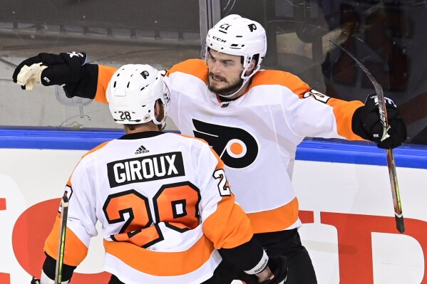 Philadelphia Flyers center Scott Laughton (21) celebrates his goal against New York Islanders goaltender Semyon Varlamov (40) with teammate left wing Claude Giroux during third-period NHL Stanley Cup Eastern Conference playoff hockey game action in Toronto, Thursday, Sept. 3, 2020. (Frank Gunn/The Canadian Press via AP)