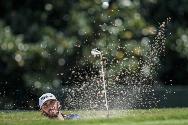 Max Homa hits out of a bunker on the second hole during the second round of the Tour Championship golf tournament, Friday, Aug. 25, 2023, in Atlanta. (AP Photo/Mike Stewart)