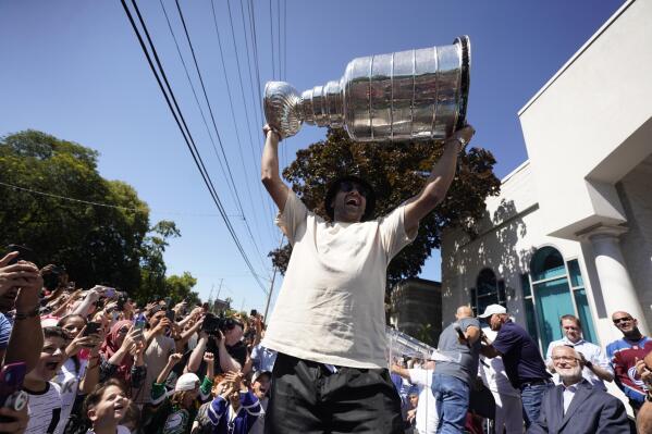 NHL player Nazem Kadri hoist the Stanley Cup in front of the London Muslim Mosque in London, Ontario on  Saturday Aug. 27, 2022. Kadri, 31, won the cup for the first time while playing with the Colorado Avalanche.  (Geoff Robins /The Canadian Press via AP)