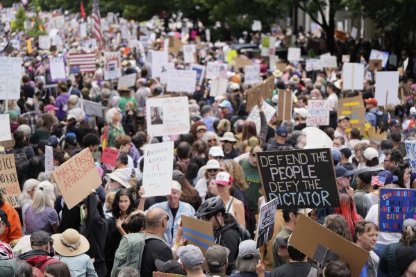 Demonstrators take part in the "No Kings" protest, Saturday, June 14, 2025, in Portland, Ore. (AP Photo/Jenny Kane)