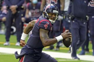 FILE - Houston Texans quarterback Deshaun Watson (4) scrambles against the Cincinnati Bengals during an NFL football game Sunday, Dec. 27, 2020, in Houston. Cleveland's blockbuster trade for the legally entangled quarterback became official Sunday, when the Browns finalized the complex deal and released statements from owners Dee and Jimmy Haslam explaining their decision to add him to their roster following the team's own extensive investigation. (AP Photo/Eric Christian Smith, FIle)
