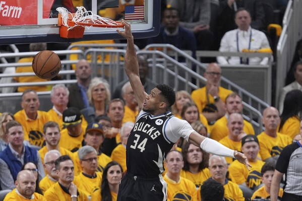 Milwaukee Bucks' Giannis Antetokounmpo (34) dunks during the second half of a first-round NBA basketball playoff game against the Indiana Pacers, Saturday, April 19, 2025, in Indianapolis. (AP Photo/Michael Conroy)