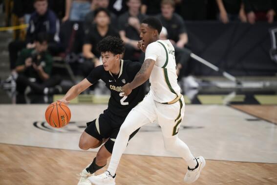 Colorado guard KJ Simpson, left, is fouled by Colorado State guard Taviontae Jackson in the second half of an NCAA college basketball game, Thursday, Dec. 8, 2022, in Boulder, Colo. (AP Photo/David Zalubowski)
