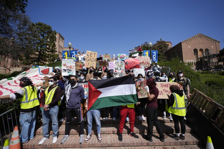 Demonstrators gather on the UCLA campus, after nighttime clashes between Pro-Israel and Pro-Palestinian groups, Wednesday, May 1, 2024, in Los Angeles. (AP Photo/Jae C. Hong)