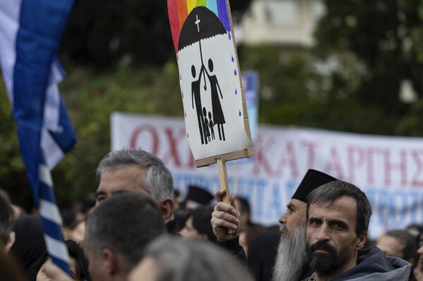 FILE - A protester raises a banner during a rally against same-sex marriage, at central Syntagma square, in Athens, Greece, Sunday, Feb. 11, 2024. Greece is becoming the first majority-Orthodox Christian nation to legalize same-sex marriage. At least for the near future, it will be the only one. The Eastern Orthodox leadership, despite lacking a single doctrinal authority like a pope, has been unanimous in opposing recognition of same-sex relationships. (APPhoto/Yorgos Karahalis, File)