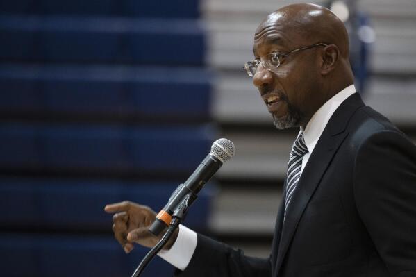 Sen. Raphael Warnock, D-Ga., speaks at Alfred E. Beach High School in Savannah, Ga., Thursday, July 8, 2021. Warnock joined fellow Democratic senators Jon Ossoff of Georgia and Tammy Baldwin of Wisconsin in introducing a bill on Monday, July 12, 2021, to require the federal government to set up a Medicaid-like health plan in states that have not expanded Medicaid plans to cover more low-income adults. (Jim Watson/Pool via AP)