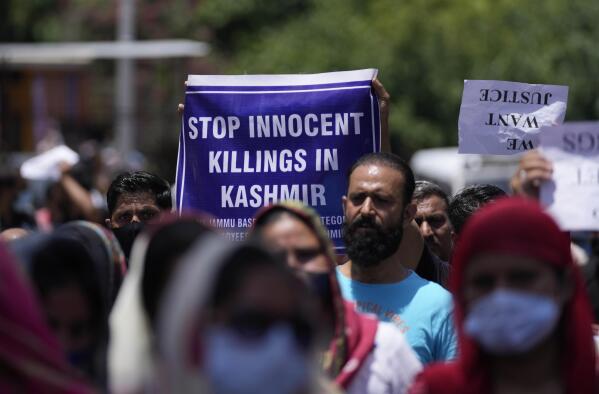 Employees of Jammu and Kashmir Teachers Association march in a protest against the killing of colleague Rajini Bala in Jammu, India, Thursday, June 2, 2022. After that killing, Hindu government employees staged protests in several areas, demanding the government relocate them from Kashmir to safer areas in the Hindu-dominated Jammu region. In another incident, assailants fatally shot a Hindu bank manager in Indian-controlled Kashmir on Thursday, said police, who blamed militants fighting against Indian rule for the attack. (AP Photo/Channi Anand)