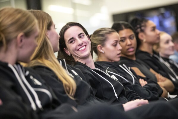 Iowa's Caitlin Clark, center, awaits her NCAA college basketball team's seed reveal during a "Selection Sunday" watch party Sunday, March 17, 2024, at Carver-Hawkeye Arena in Iowa City, Iowa. (Geoff Stellfox/The Gazette via AP)