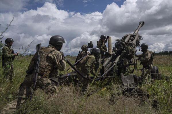 FILE - Ukrainian servicemen prepare to fire at Russian positions from a U.S.-supplied M777 howitzer in Kharkiv region, Ukraine, July 14, 2022. Supplies of Western weapons, including U.S. HIMARS multiple rocket launchers, has significantly boosted the Ukrainian military's capability, allowing it to target Russian munitions deports, bridges and other key facilities with precision and impunity. (AP Photo/Evgeniy Maloletka, File)