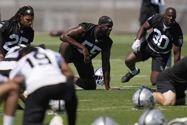 Las Vegas Raiders defensive end Chandler Jones, center, warms up during practice at the NFL football team's practice facility Thursday, June 2, 2022, in Henderson, Nev. (AP Photo/John Locher)