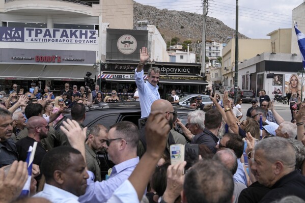 FILE - Kyriakos Mitsotakis, leader of Greece's conservative New Democracy party, waves to supporters on the island of Salamina, near Athens, Greece, on Tuesday, June 13, 2023. Greeks heading to the polls on Sunday June 25, for a second general election in five weeks, with conservative leader Kyriakos Mitsotakis expected to win re-election by a large margin. (AP Photo/Thanassis Stavrakis, file)