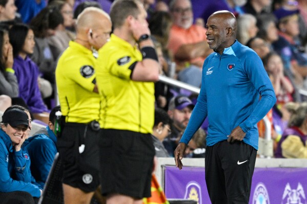 Chicago Red Stars head coach Lorne Donaldson, right, talks with referees on the sideline during an NWSL soccer match against the Orlando Pride, March 29, 2024, in Orlando, Fla. (AP Photo/Phelan M. Ebenhack, File)