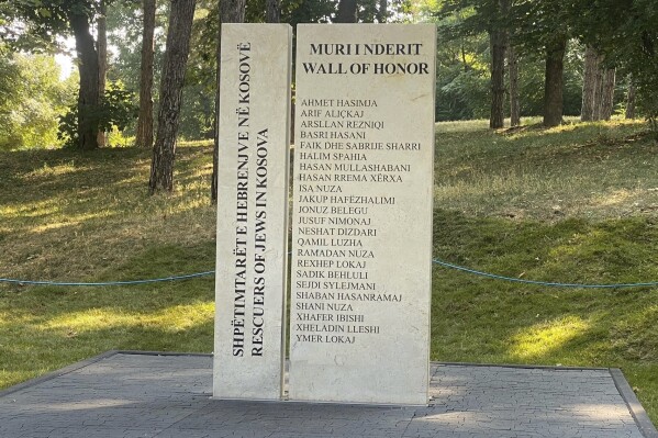 A view of a statue honoring 23 Kosovo Albanians who rescued Jews from the Holocaust during World War II, after an inauguration, in the capital, Pristina, Wednesday, Aug. 23, 2023. The “Wall of Honor” statue was placed in a park in Pristina in the presence of some of the rescuers' descendants, political leaders, and the U.S. and German ambassadors. (AP Photo/Sylejman Kllokoqi)