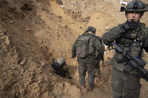Israeli soldiers enter a Hamas tunnel underneath a cemetery during the ground offensive on the Gaza Strip in Khan Younis, Saturday, Jan. 27, 2024. Hamas is widely believed to be holding the hostages in heavily guarded tunnels deep underground, using them as human shields for its top leaders and bargaining chips for the release of thousands of Palestinian prisoners. These include high-profile militants involved in attacks that killed Israeli civilians. (AP Photo/Sam McNeil)