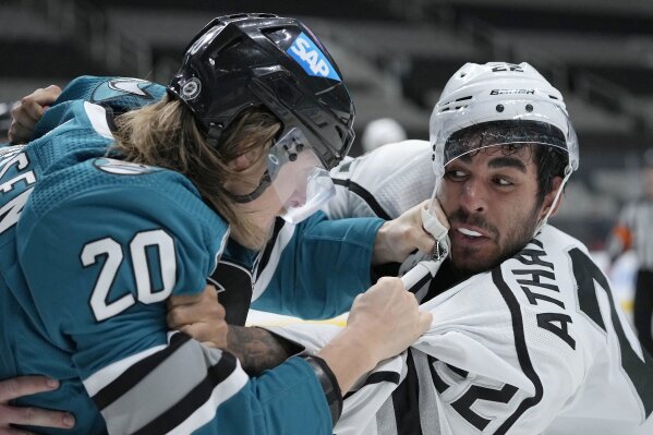 San Jose Sharks left wing Marcus Sorensen (20) fights with Los Angeles Kings left wing Andreas Athanasiou (22) during the second period of an NHL hockey game Friday, April 9, 2021, in San Jose, Calif. (AP Photo/Tony Avelar)