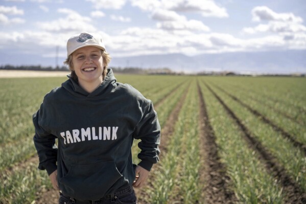 This 2022 photo shows Kate Nelson in Bakersfield, Calif,, after attending a Farmlink Project food delivery in Bakersfield to support the farmer community. Farmlink Project is one of numerous nonprofits established by Gen Z founders during the COVID-19 pandemic. (Owen Dubeck/Farmlink Project via AP)