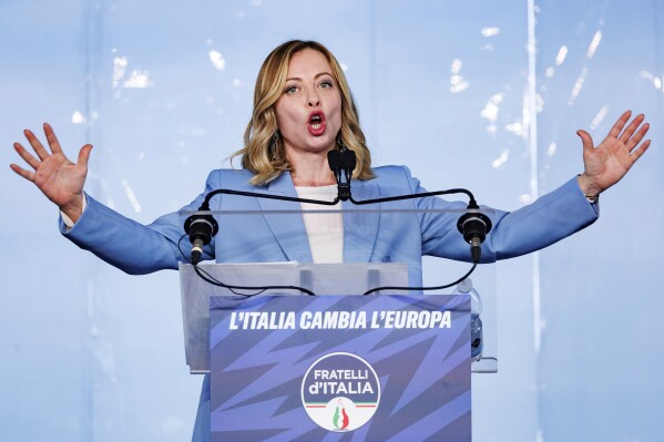 FILE - Italian Prime Minister Giorgia Meloni speaks on the last of a three-day Brothers of Italy party conference ahead of the June elections for the European Parliament, in Pescara, Italy, Sunday, April 28, 2024. Writing on lecture stand reads in Italian "Italy changes Europe." Meloni's popularity is expected to ensure significant gains for her far-right Brothers of Italy Party in European Parliamentary elections, and European Commission President Ursula Von der Leyen, who has exhibited a liking for Meloni, has already floated the notion of bringing her into a coalition if needed. (Roberto Monaldo/LaPresse via AP, File)