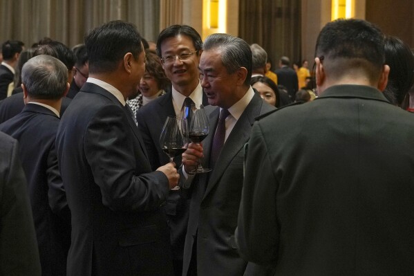 Chinese Foreign Minister Wang Yi, center, toasts with invited guests after delivered a speech at a reception for Commemoration of the 45th Anniversary of China-U.S. Diplomatic Relations at the Diaoyutai Guest House in Beijing, Friday, Jan. 5, 2024. (AP Photo/Andy Wong, Pool)
