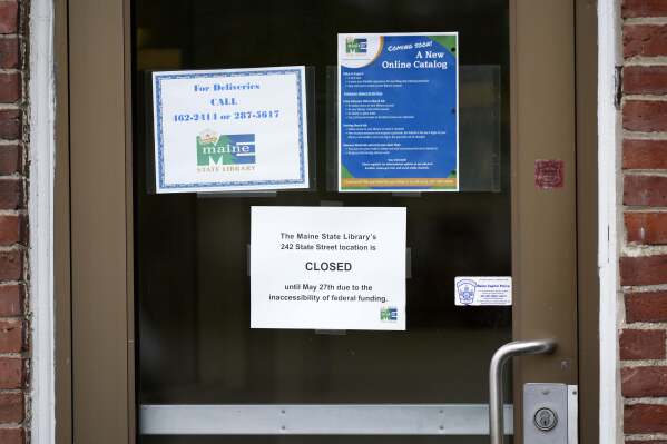 A sign announces the extended closure of the Maine State Library, Wednesday, May 7, 2025, in Augusta, Maine. (AP Photo/Robert F. Bukaty)