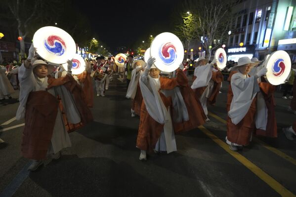 Buddhist monks walk in a lantern parade during the Yeon Deung Hoe, or Lotus Lantern Festival, ahead of the Buddha's birthday on May 5, in downtown Seoul, South Korea, Saturday, April 26, 2025. (AP Photo/Lee Jin-man)