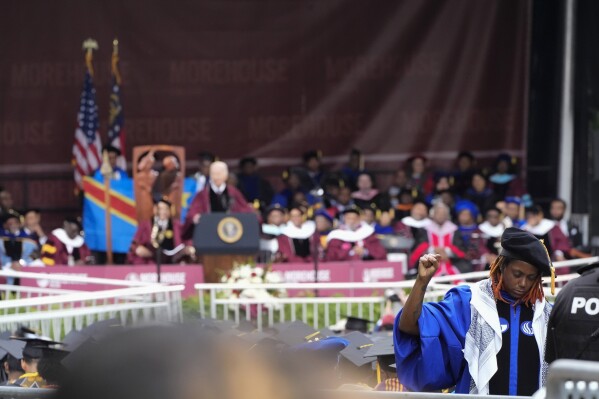 An attendee stands with their back to President Joe Biden as Biden speaks to graduating students at the Morehouse College commencement Sunday, May 19, 2024, in Atlanta. (AP Photo/John Bazemore)