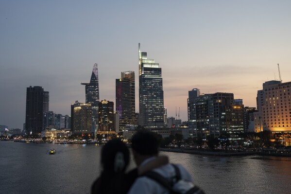 A couple view the skyline of Ho Chi Minh City, Vietnam, Jan. 12, 2024. (AP Photo/Jae C. Hong)