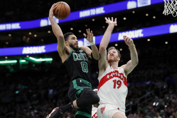 Boston Celtics' Jayson Tatum (0) shoots against Toronto Raptors' Jakob Poeltl (19) during the first half of an NBA basketball game Friday, April 7, 2023, in Boston. (AP Photo/Michael Dwyer)