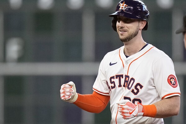Houston Astros' Kyle Tucker celebrates after tying a baseball game with an RBI double during the fourth inning against the Texas Rangers, Saturday, April 13, 2024, in Houston. (AP Photo/Kevin M. Cox)