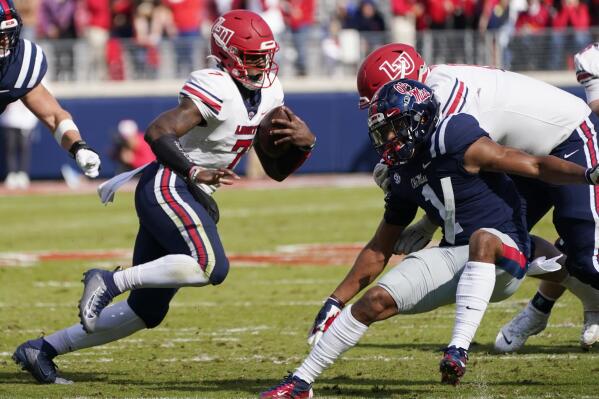 Liberty quarterback Malik Willis (7) runs past Mississippi defensive back Jake Springer (1) during the second half of an NCAA college football game in Oxford, Miss., Saturday, Nov. 6, 2021. Mississippi won 27-14. (AP Photo/Rogelio V. Solis)