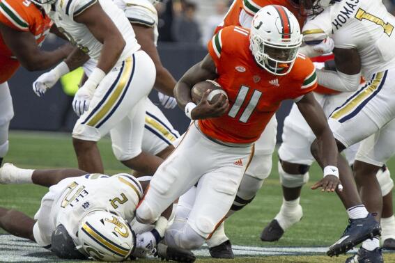 Miami quarterback Jacurri Brown (11) is tackled by Georgia Tech's linebacker Ayinde Eley (2) in the first half of an NCAA college football game Saturday, Nov. 12, 2022, in Atlanta. (AP Photo/Hakim Wright Sr.)