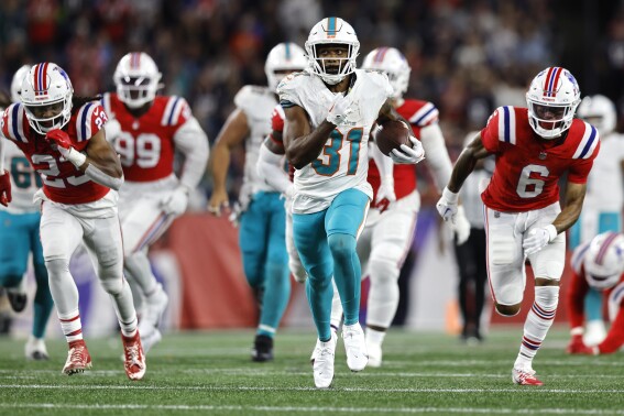 Miami Dolphins running back Raheem Mostert (31) out runs the New England Patriots for a 43-yard touchdown during the fourth quarter of an NFL football game, Sunday, Sept. 17, 2023, in Foxborough, Mass. (AP Photo/Michael Dwyer)