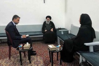This handout photo from the office of Grand Ayatollah Ali al-Sistani shows Iraq's top Shiite cleric Grand Ayatollah Ali al-Sistani, center, meeting with U.N. envoy to Iraq Jeanine Hennis-Plasschaer...