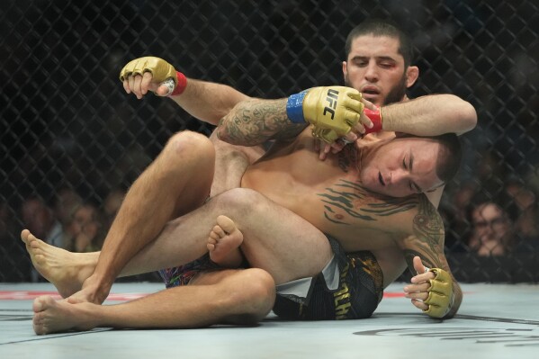 Russia's Islam Makhachev, above, works against Dustin Poirier during the first round of a lightweight title bout at the UFC 302 mixed martial arts even early Sunday, June 2, 2024, in Newark, N.J. Makhachev won the bout. (AP Photo/Frank Franklin II)