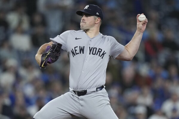 New York Yankees pitcher Carlos Rodon works against the Toronto Blue Jays during the first inning of a baseball game in Toronto on Tuesday, April 16, 2024. (Nathan Denette/The Canadian Press via AP)