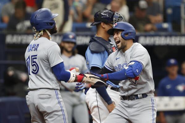 Toronto Blue Jays' George Springer, right, celebrates with teammate Ric Tapia after hitting a two-run home run against the Tampa Bay Rays during the third inning of a baseball game Sunday, Sept. 25, 2022, in St. Petersburg, Fla. (AP Photo/Scott Audette)