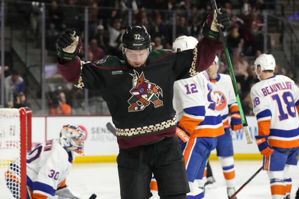 Arizona Coyotes center Travis Boyd (72) reacts after scoring a goal against the New York Islanders in the third period during an NHL hockey game, Friday, Dec. 16, 2022, in Tempe, Ariz. Arizona won 5-4. (AP Photo/Rick Scuteri)