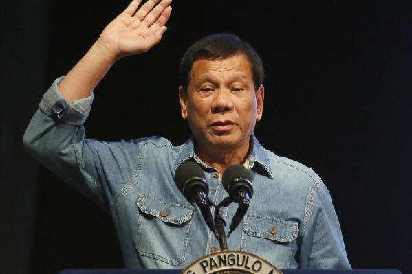 FILE - Philippine President Rodrigo Duterte gestures as addresses thousands of the country's municipal councilors during its 10th National Congress Wednesday, March 8, 2017, in Pasay city south of Manila, Philippines. The Philippine justice secretary said Friday, Jan. 27, 2023, that any investigation by the International Criminal Court into the widespread killings of suspects in an anti-drugs crackdown under former President Rodrigo Duterte would be “totally unacceptable.” (AP Photo/Bullit Marquez, File)