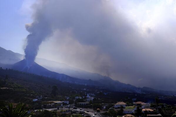 A volcano continues to erupt near El Paso on the canary island of La Palma, Spain, Saturday Oct. 9, 2021. A new lava flow has belched out from the La Palma volcano and it threatens to spread more destruction on the Atlantic Ocean island where molten rock streams have already engulfed over 1,000 buildings. The partial collapse of the volcanic cone overnight sent a new lava stream Saturday heading toward the western shore of the island. (AP Photo/Daniel Roca)